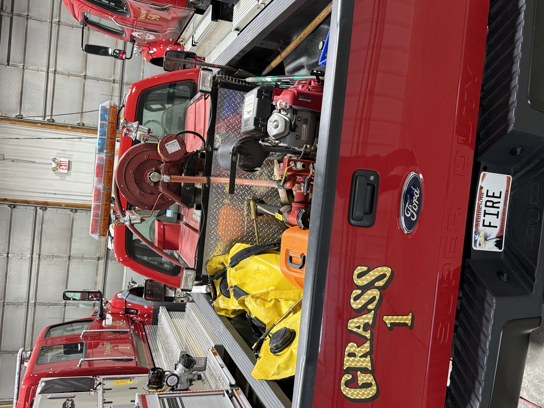 In the bed: the pump, hand tools, and the yellow wildland (grass-fire) gear bags.
