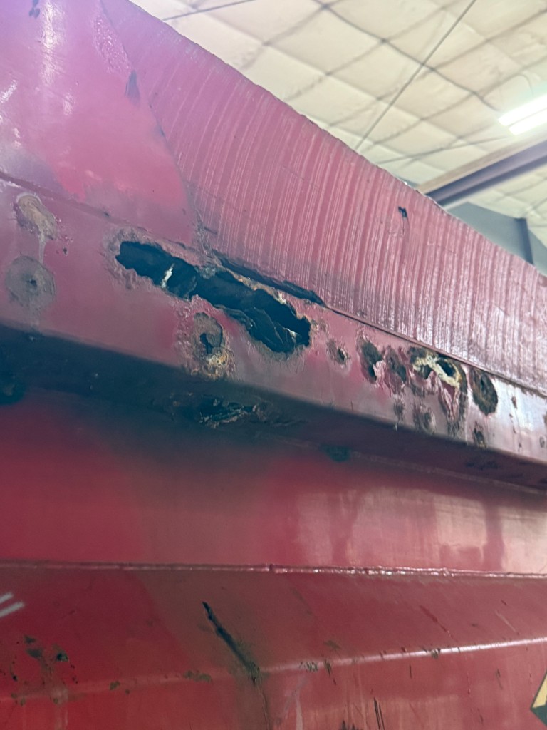 2000 Sterling dump box rail with rusted-through holes