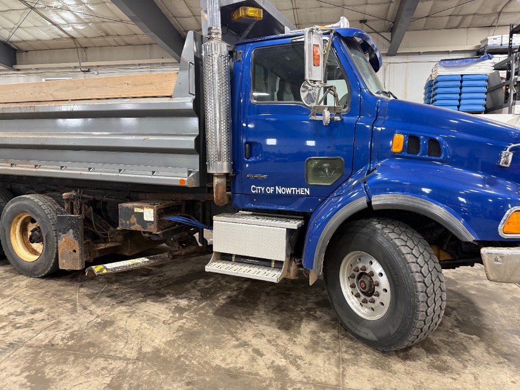 Driver’s side: “City of Nowthen.” The dump box does not sit all the way down on the frame.