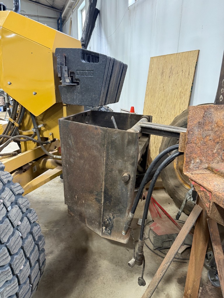 Rear ballast box (Husky suitcase weights) and the hydraulic hookups used to run a towed attachment.